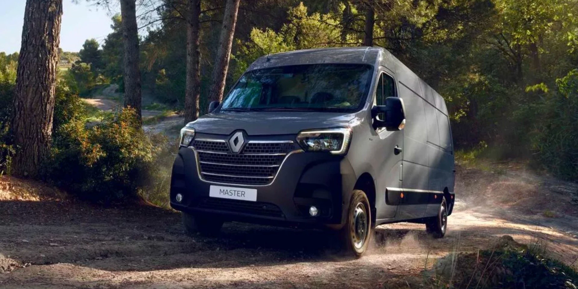 grey renault master on forest road front view